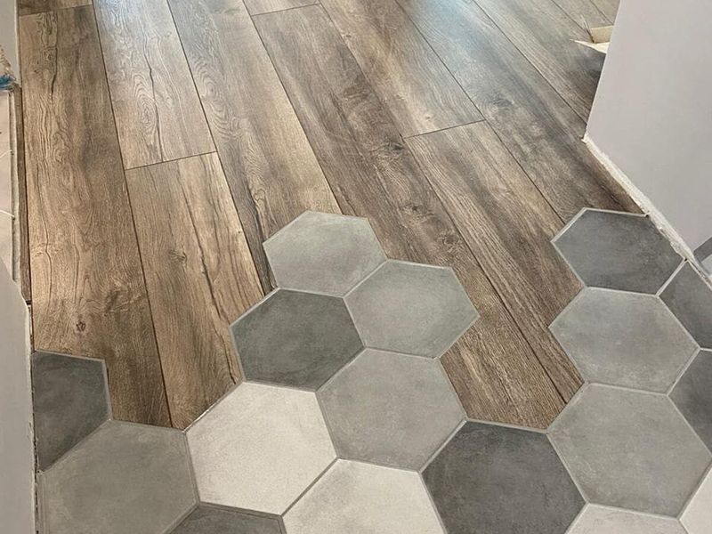 Hexagonal floor tile meeting a wood-effect floor