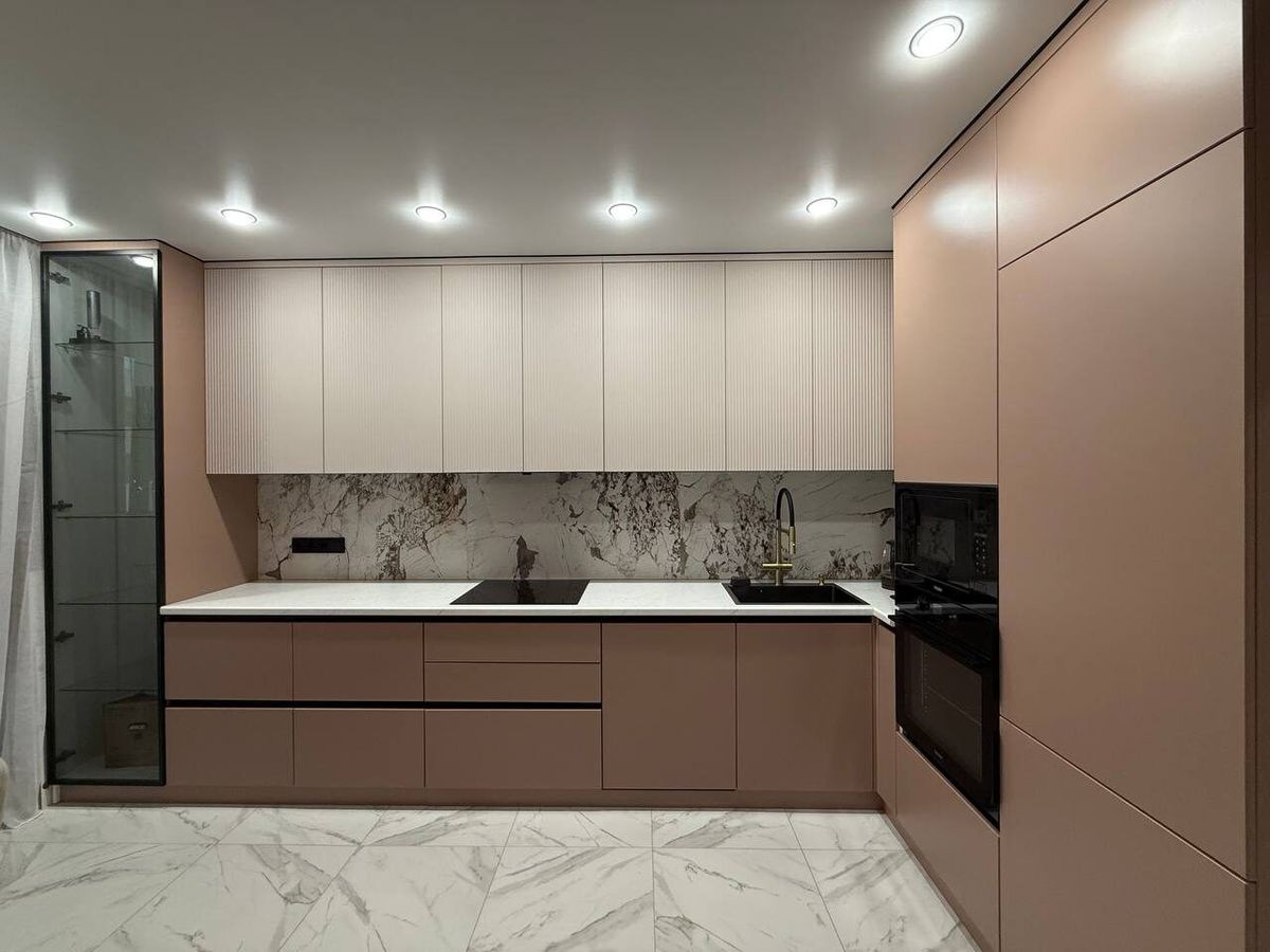 Beige kitchen with terracotta cabinets and a marble floor