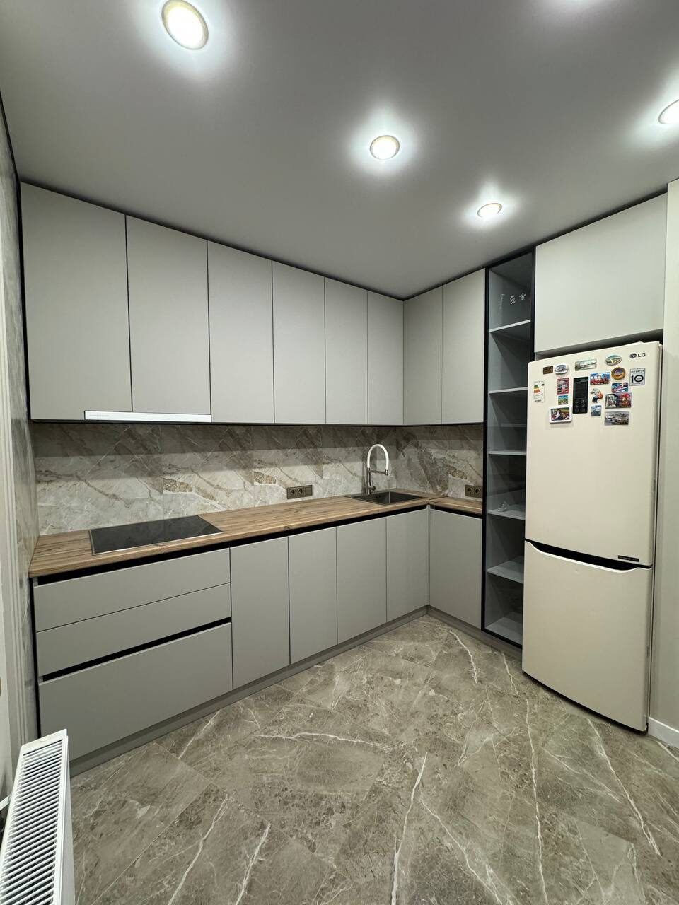 Cream corner kitchen with a wooden worktop after renovation