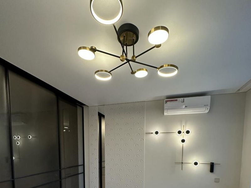 Ceiling and wall lights in a living room after a Prague flat renovation