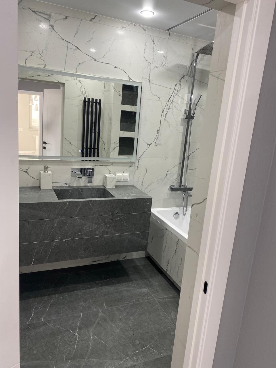 Mirror and Calacatta marble tiling after a bathroom renovation