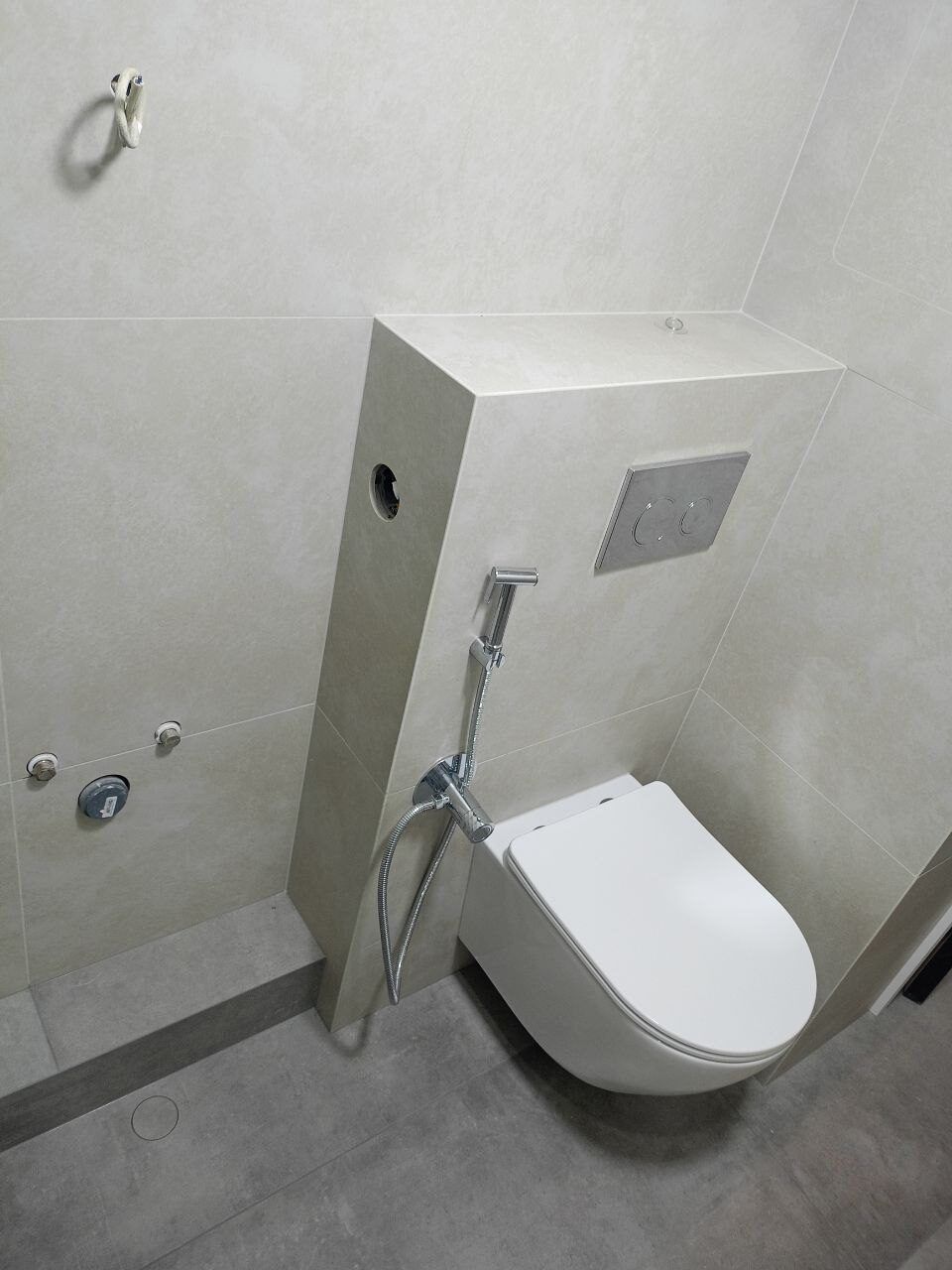 Wall-hung toilet in a small white renovated bathroom, Prague