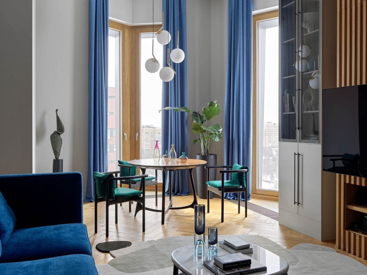 Apartment renovation - living room with dining area and blue curtains, Prague