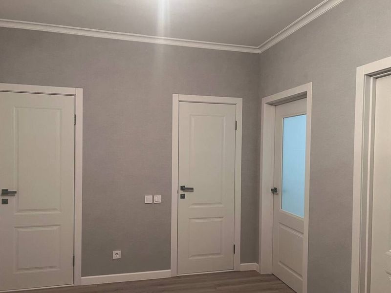 Door openings with white frames in a flat after a Prague renovation