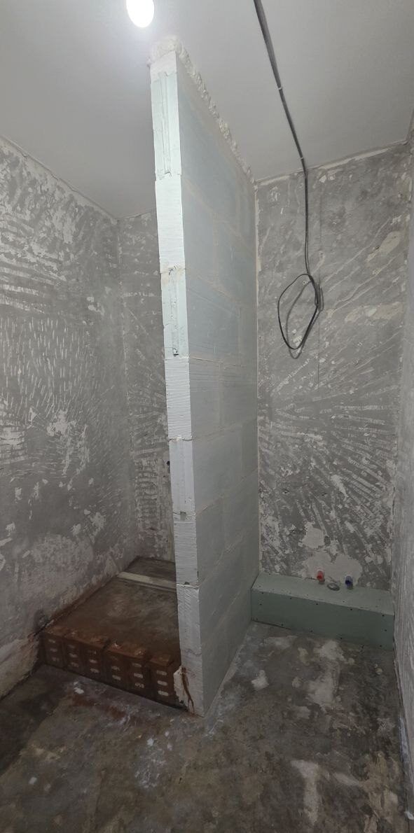 Bare shower partition wall before tiling
