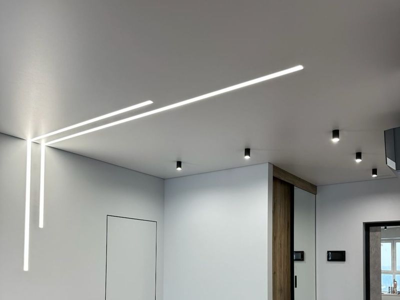 Ceiling with recessed linear LED fittings in a flat after a Prague renovation
