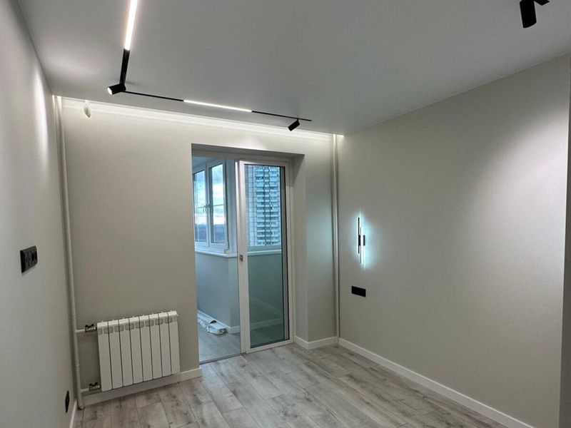 Track and recessed spotlights in a room ceiling