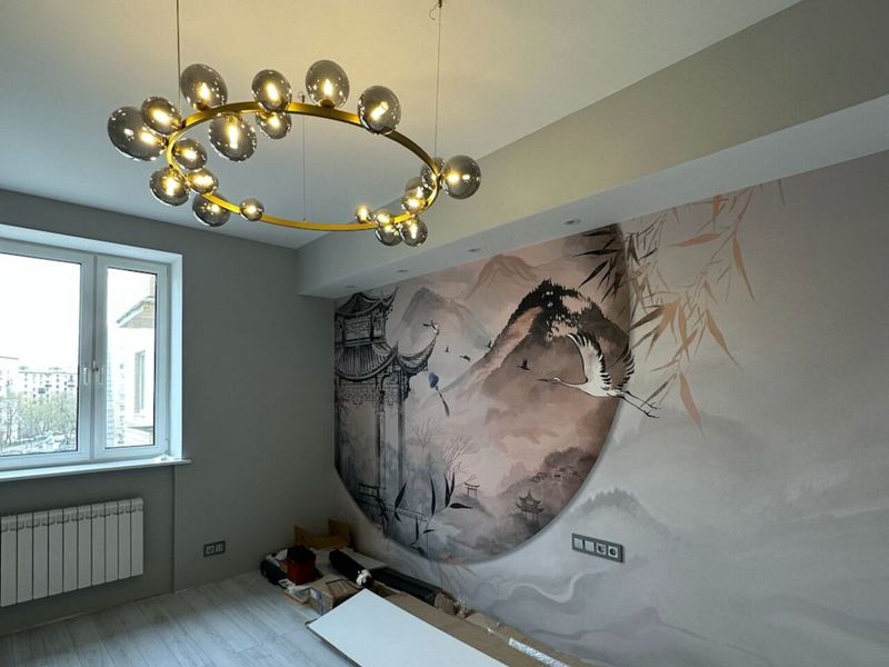 Living room with a statement chandelier and a large-format wall mural after a Prague renovation